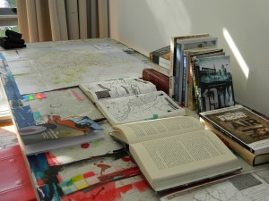 Image of desk with books and maps