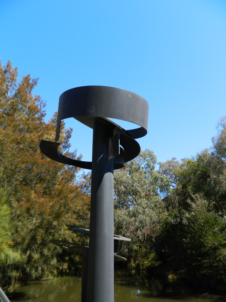 Inge King sculpture Dialogue of Circles - two massive steel plinths hold spirals.