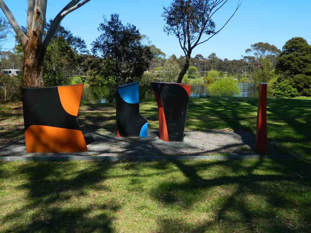 Inge King sculpture, Group of Boulders: short painted steel blocks facing each other.